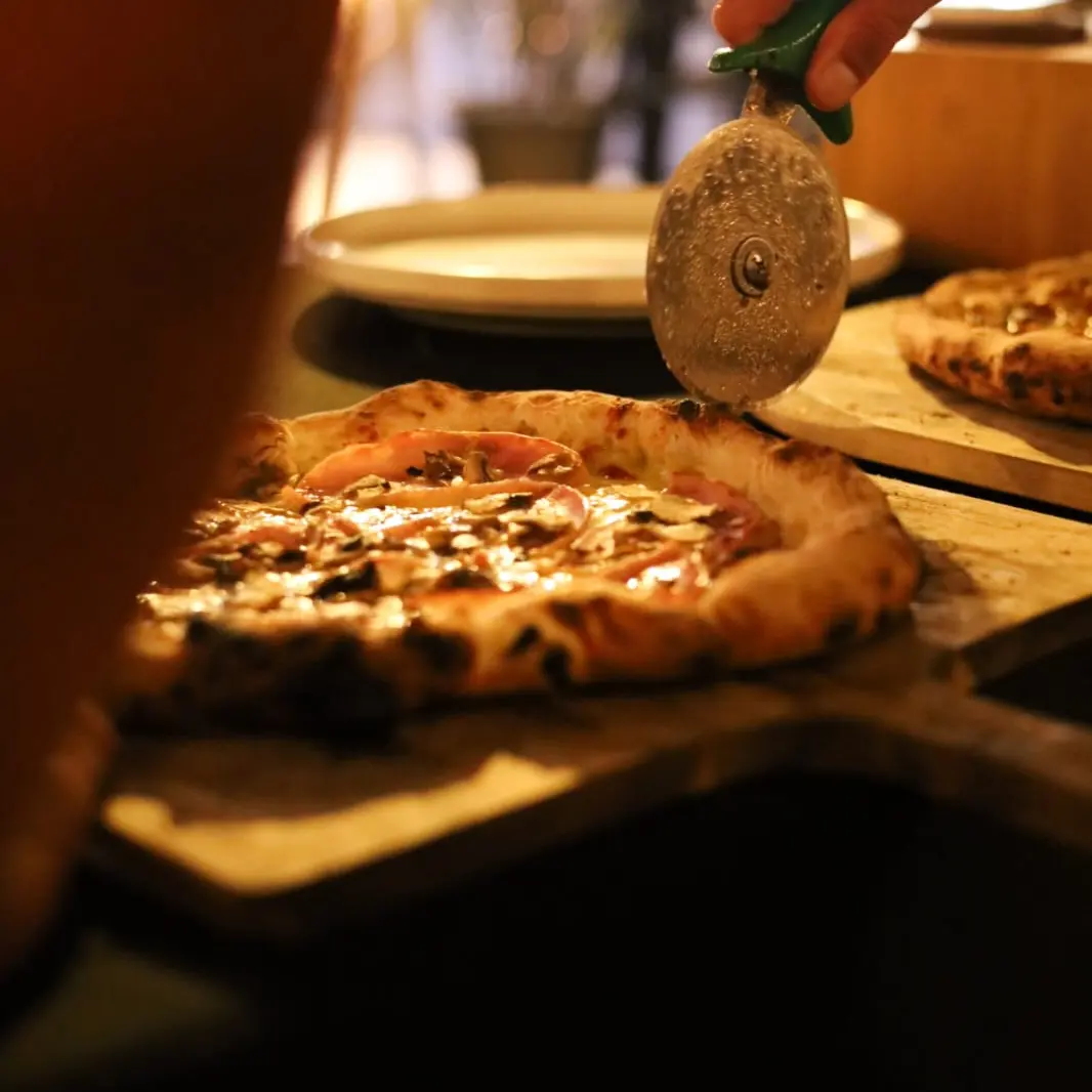 Slicing a fresh pizza