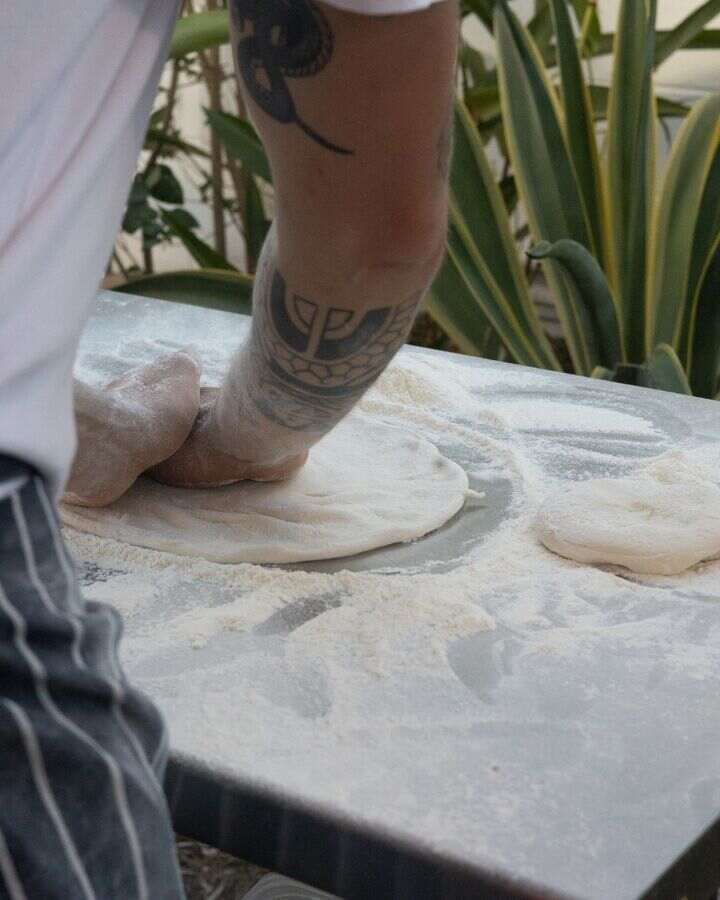 Hand-stretching the dough