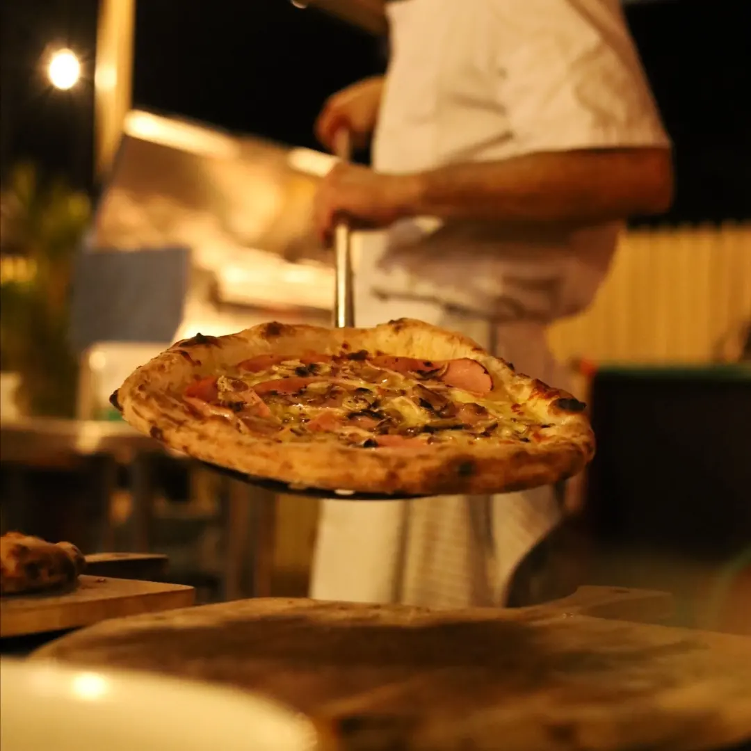 Pizza lifted on the peel